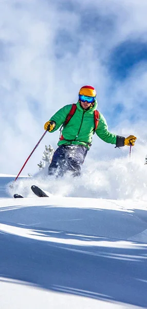 man skiing down snowing hill